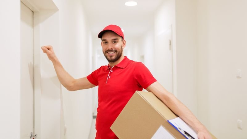 deliverables A man bringing a package, knocking on a door.