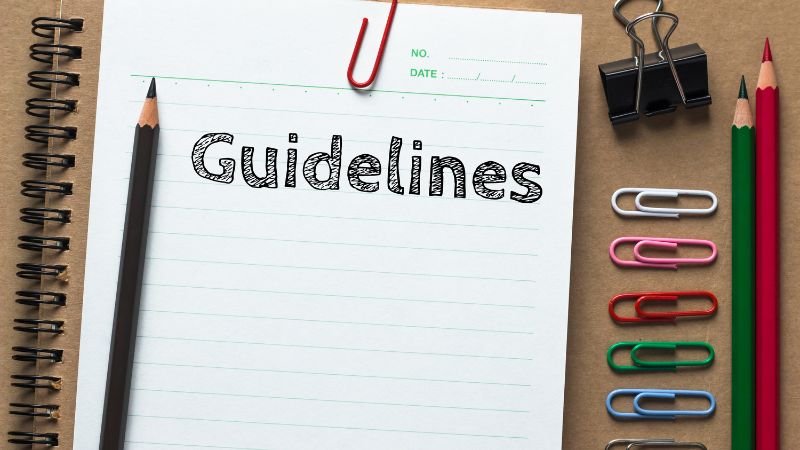 A pencil on a notebook and paper clips.