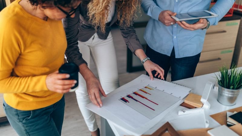 People watching chart diagrams.